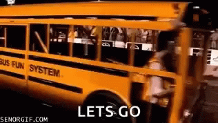 a yellow school bus with the words let 's go on it