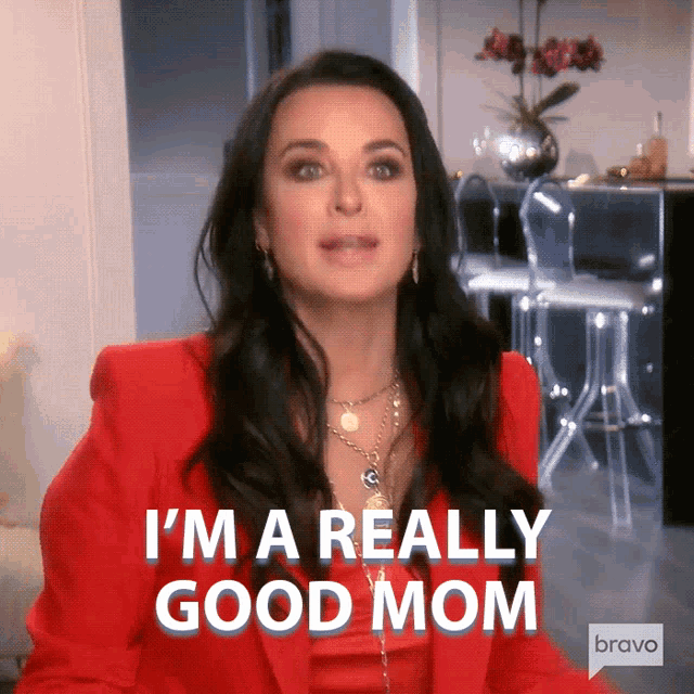 a woman in a red jacket says i 'm a really good mom bravo